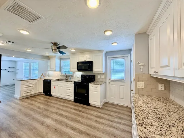 a kitchen with stainless steel appliances a stove sink and refrigerator