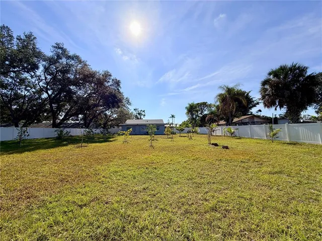 a view of house with backyard and seating area