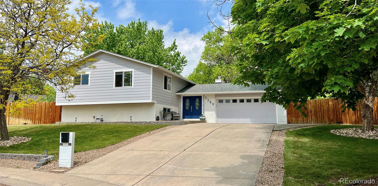 5389 West Roxbury Place Littleton, CO 80128 - Photo 1 of 31 a front view of house with yard and trees