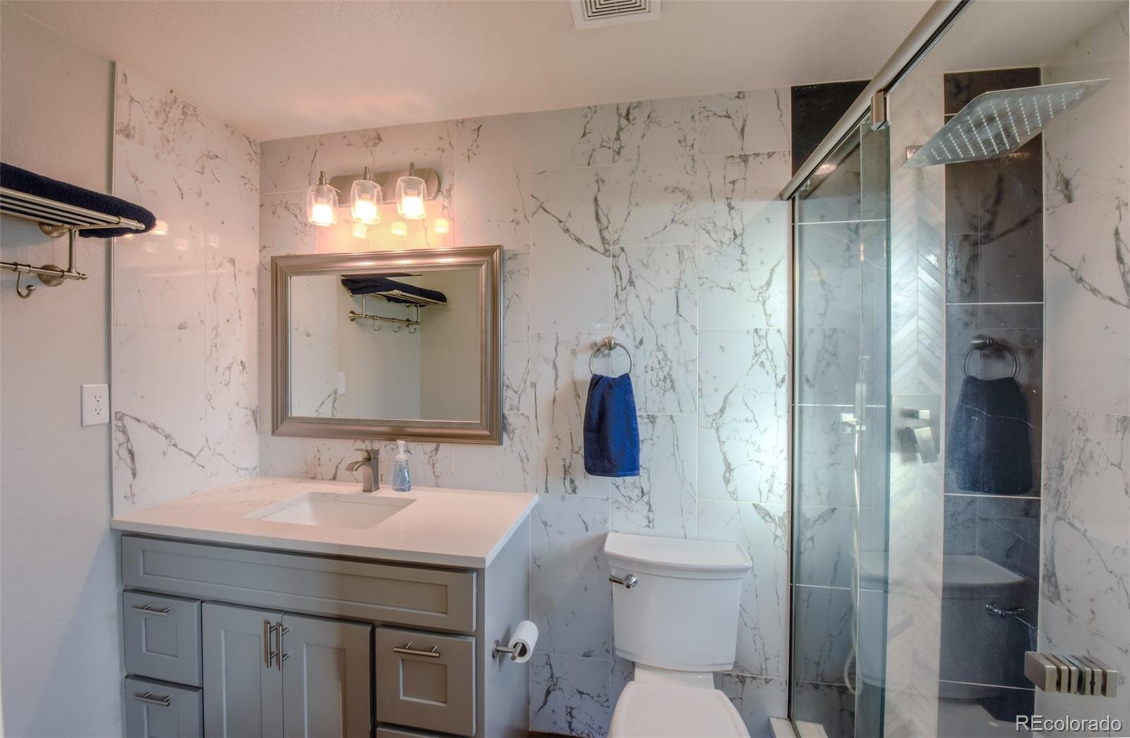 5389 West Roxbury Place Littleton, CO 80128 - Photo 11 of 31 a bathroom with a sink toilet and shower