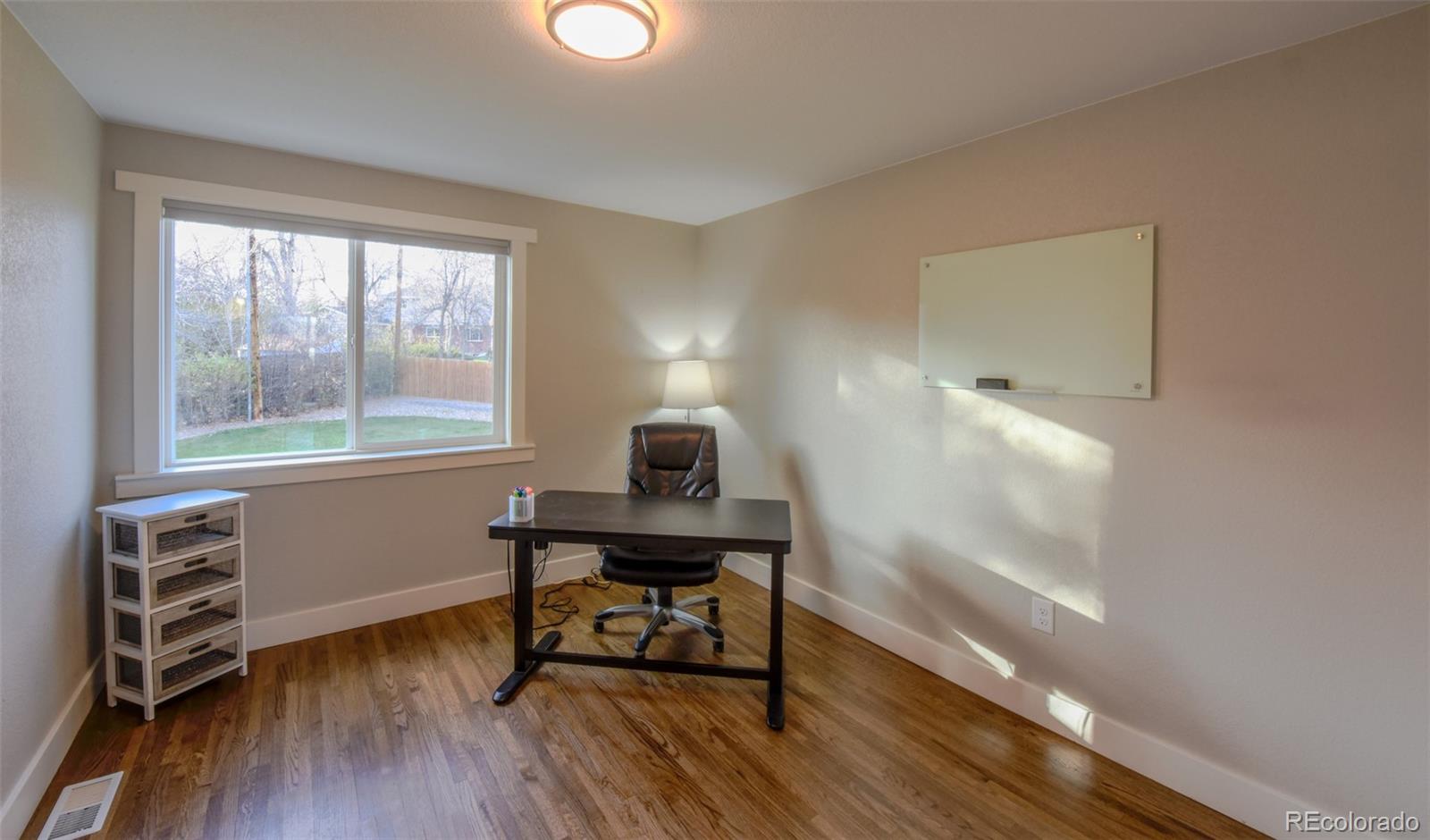 5389 West Roxbury Place Littleton, CO 80128 - Photo 12 of 31 a view of a workspace with furniture and a window