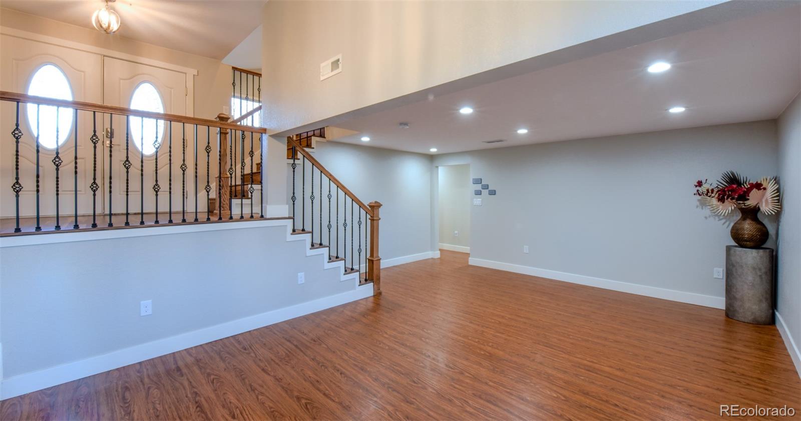 5389 West Roxbury Place Littleton, CO 80128 - Photo 17 of 31 a view of a hallway with wooden floor
