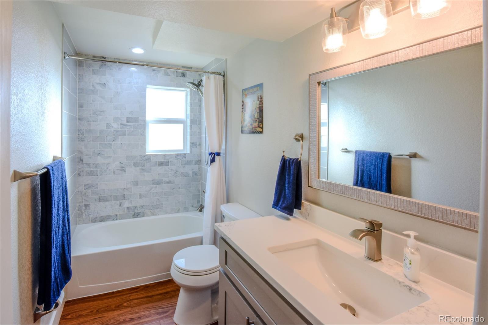 5389 West Roxbury Place Littleton, CO 80128 - Photo 21 of 31 a bathroom with a sink toilet bathtub and vanity