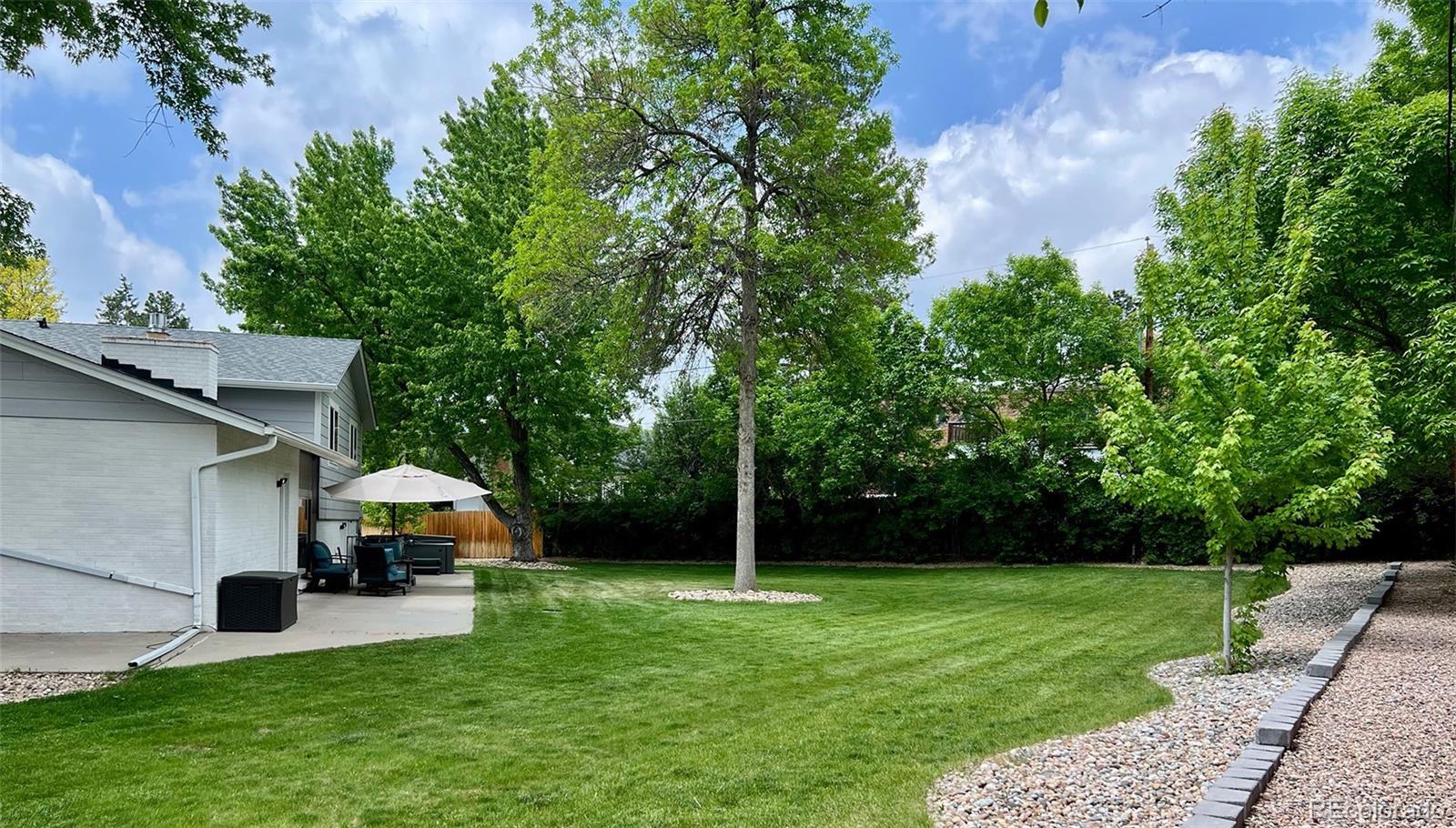 5389 West Roxbury Place Littleton, CO 80128 - Photo 27 of 31 a front view of a house with garden