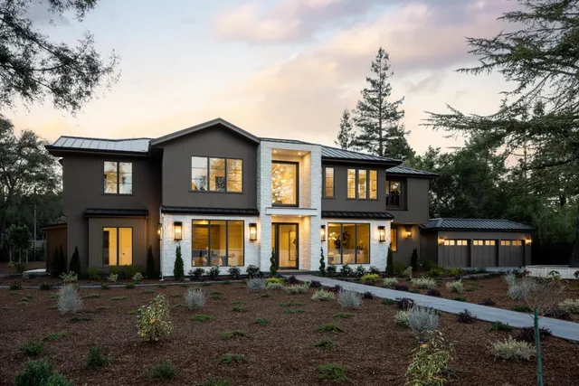 a front view of a residential apartment building with a yard