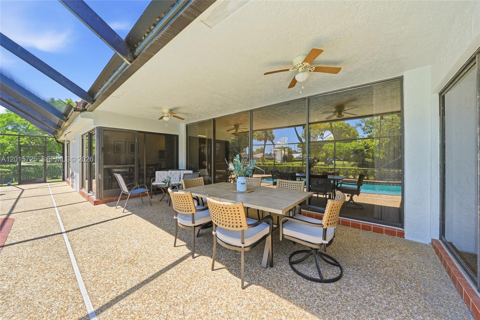 11008 Boca Woods Lane Boca Raton, FL 33428 - Photo 41 of 70 a room with lots of tables a large window and chairs