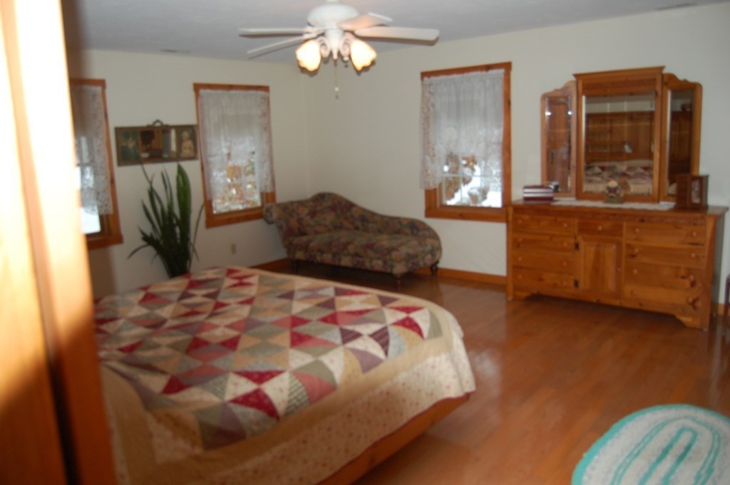 215 Crouch Road Warren, MA 01092 - Photo 15 of 33 a bedroom with a bed dresser and wooden floor