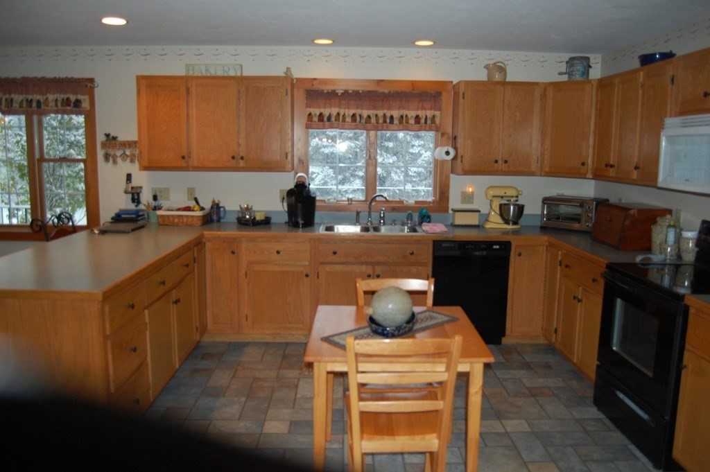 215 Crouch Road Warren, MA 01092 - Photo 8 of 33 a kitchen with stainless steel appliances granite countertop a sink a stove and a refrigerator