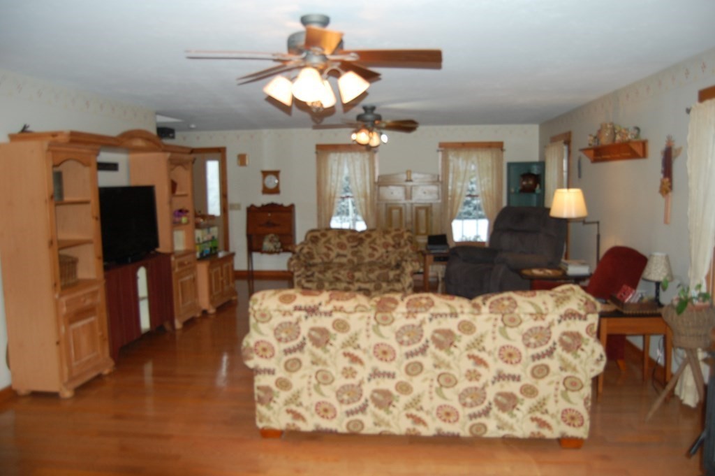 215 Crouch Road Warren, MA 01092 - Photo 9 of 33 a living room with furniture a chandelier and a flat screen tv
