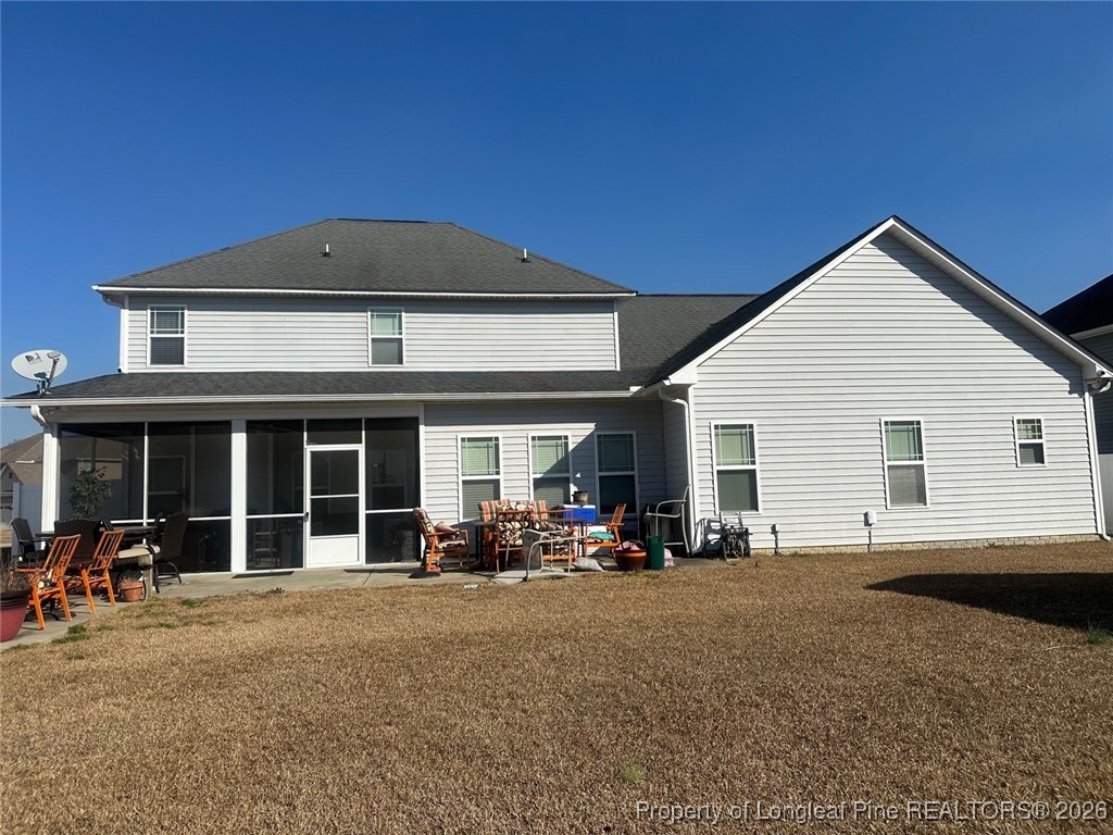 278 Exeter Drive Raeford, NC 28376 - Photo 2 of 3 a view of a house with a barbeque and bench next to a yard