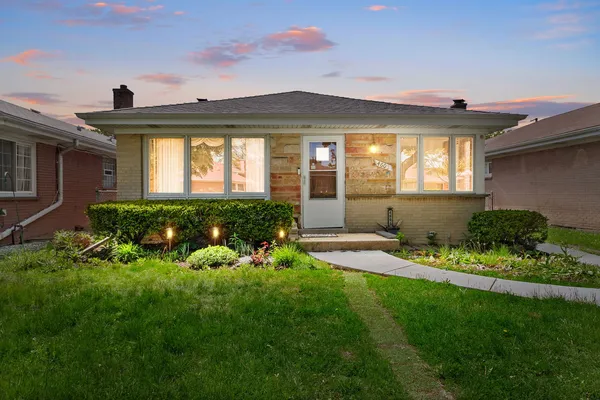 a front view of a house with a garden