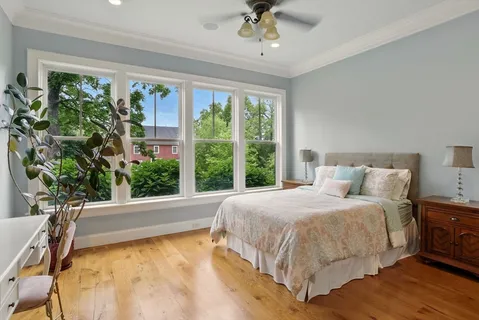 a large bed sitting in a bedroom next to a window