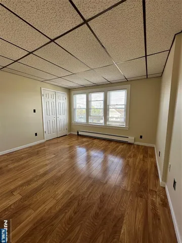 a view of a room with wooden floor and windows