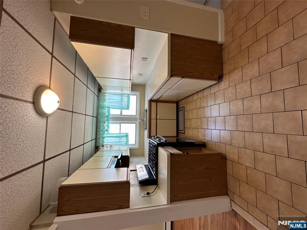 622-624 8th Street, Unit 2L Lyndhurst, NJ 07071 - Photo 16 of 23 a large kitchen with stainless steel appliances granite countertop a sink and cabinets