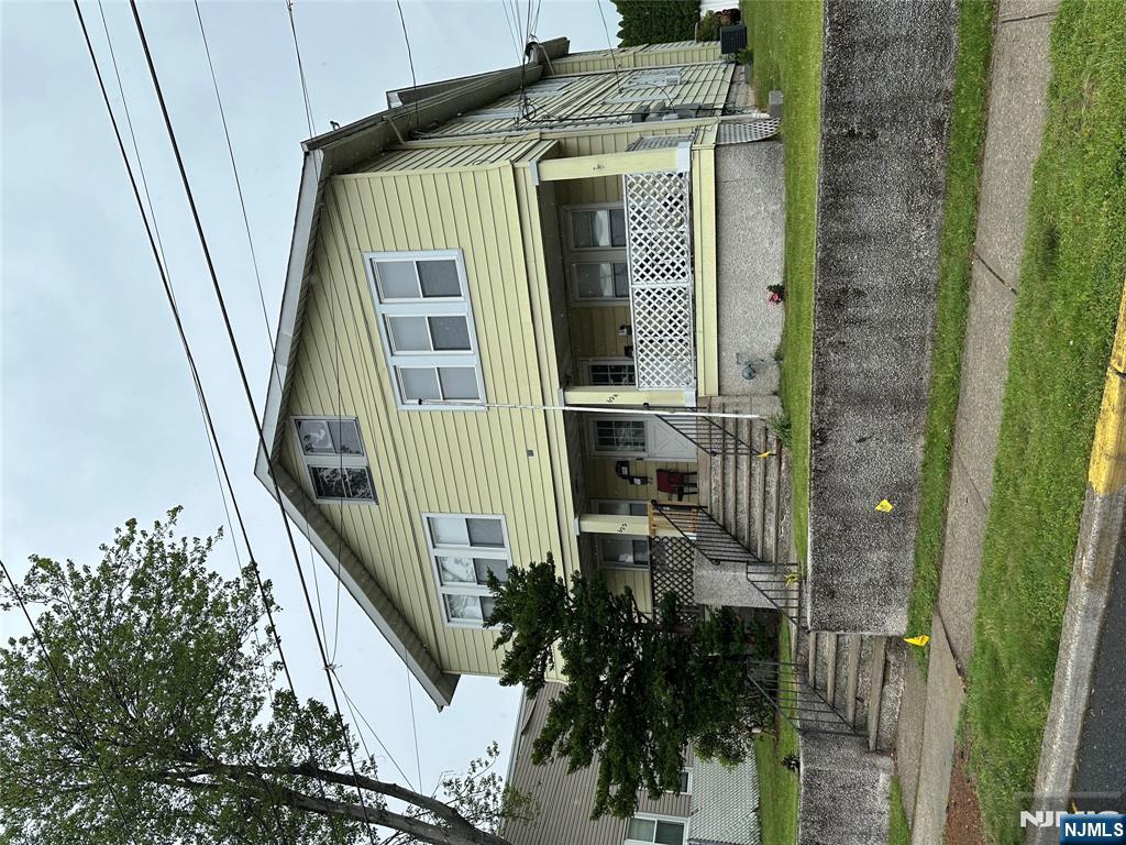 622-624 8th Street, Unit 2L Lyndhurst, NJ 07071 - Photo 23 of 23 a front view of a house with a garden