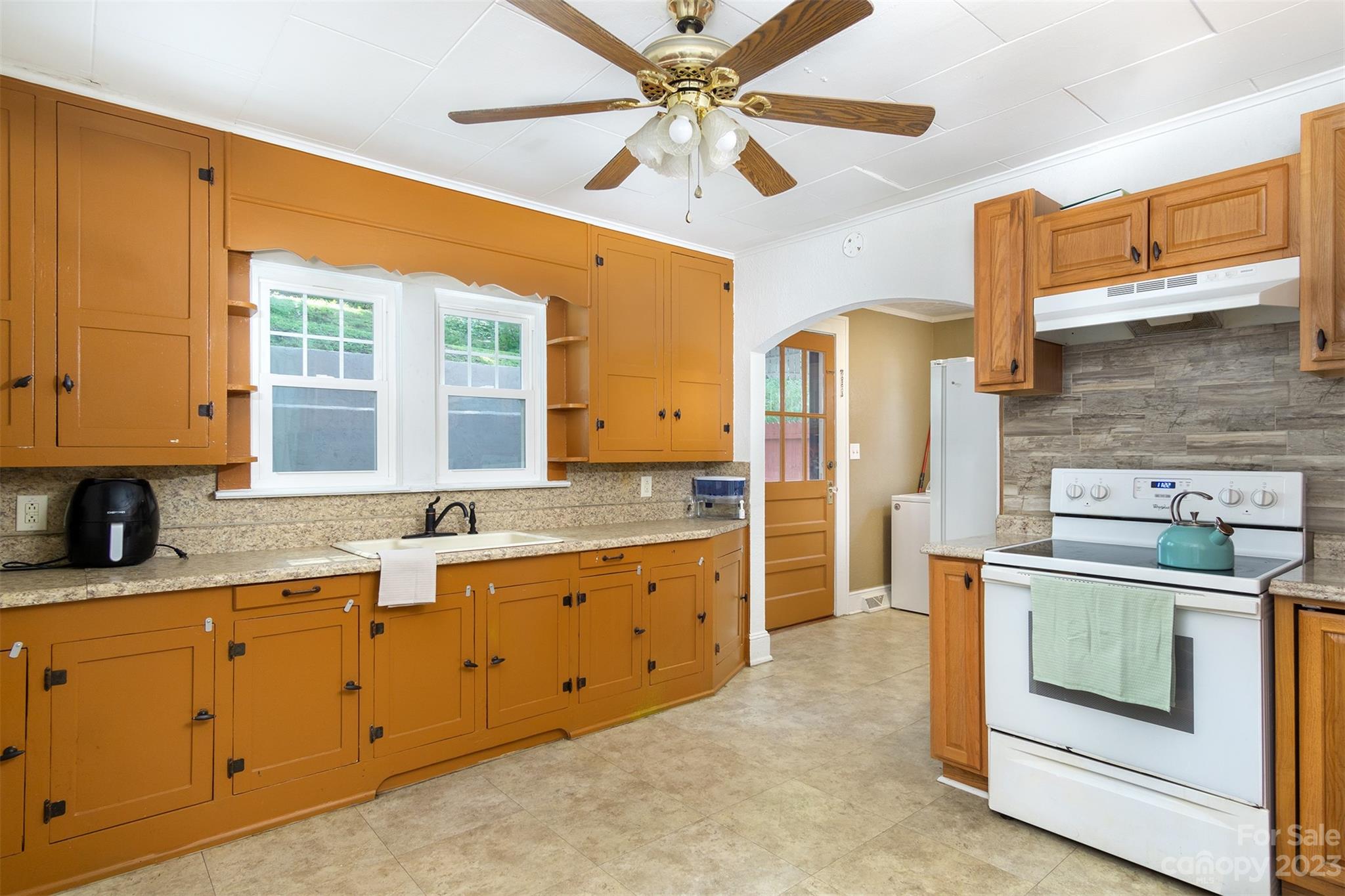 404 Huffman Street Morganton, NC 28655 - Photo 11 of 27 a kitchen with stainless steel appliances granite countertop a stove and a sink