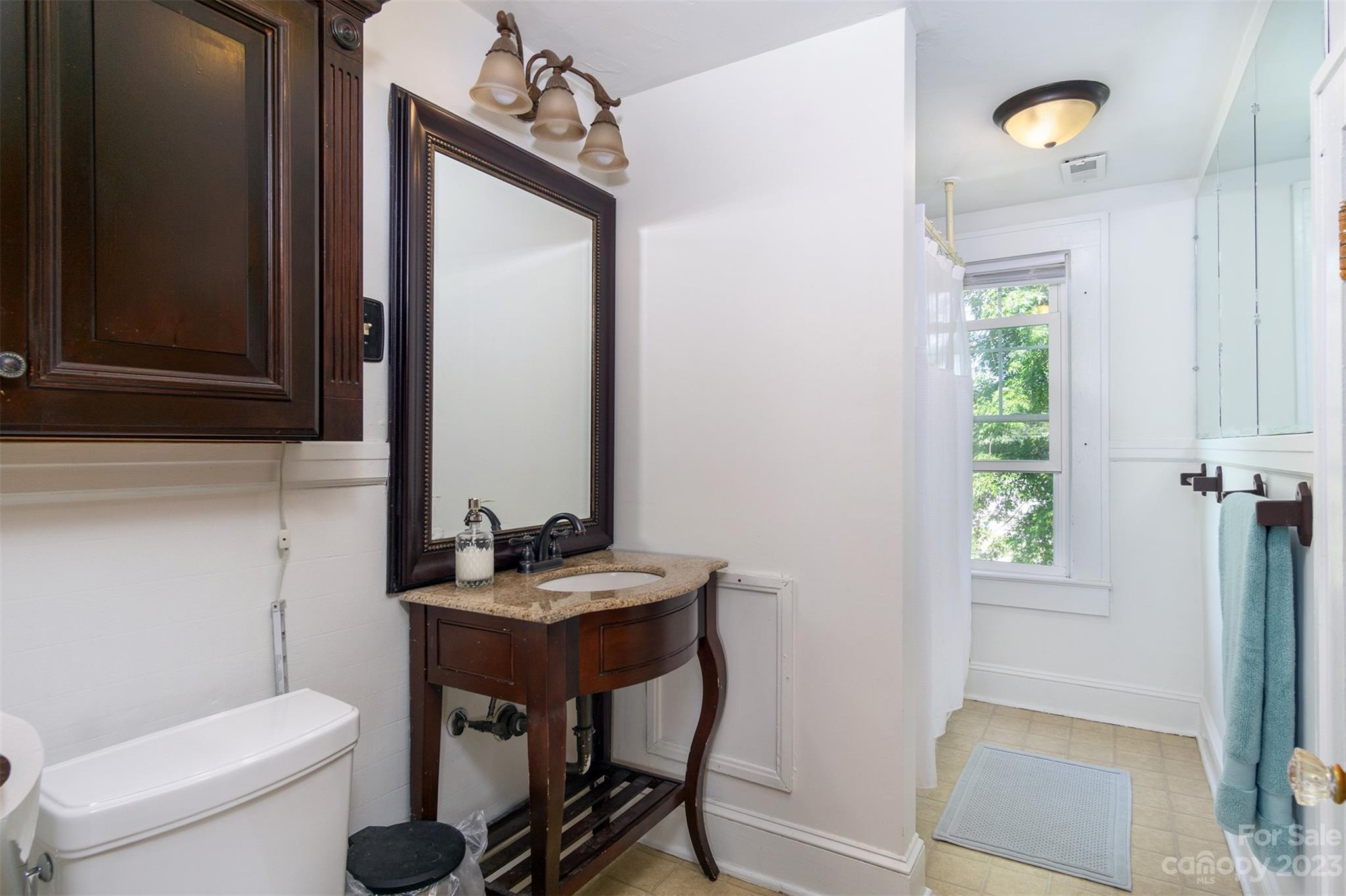 404 Huffman Street Morganton, NC 28655 - Photo 13 of 27 a bathroom with a sink a toilet and a mirror