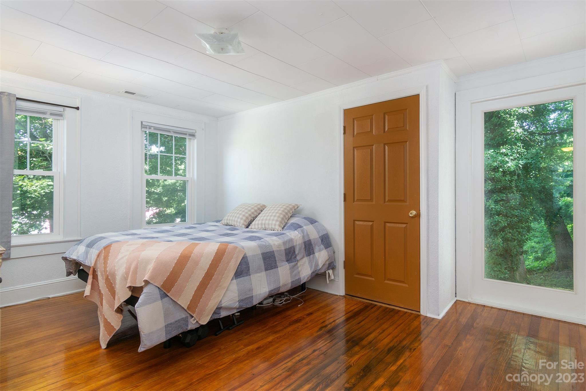 404 Huffman Street Morganton, NC 28655 - Photo 14 of 27 a bedroom with a bed and wooden floor