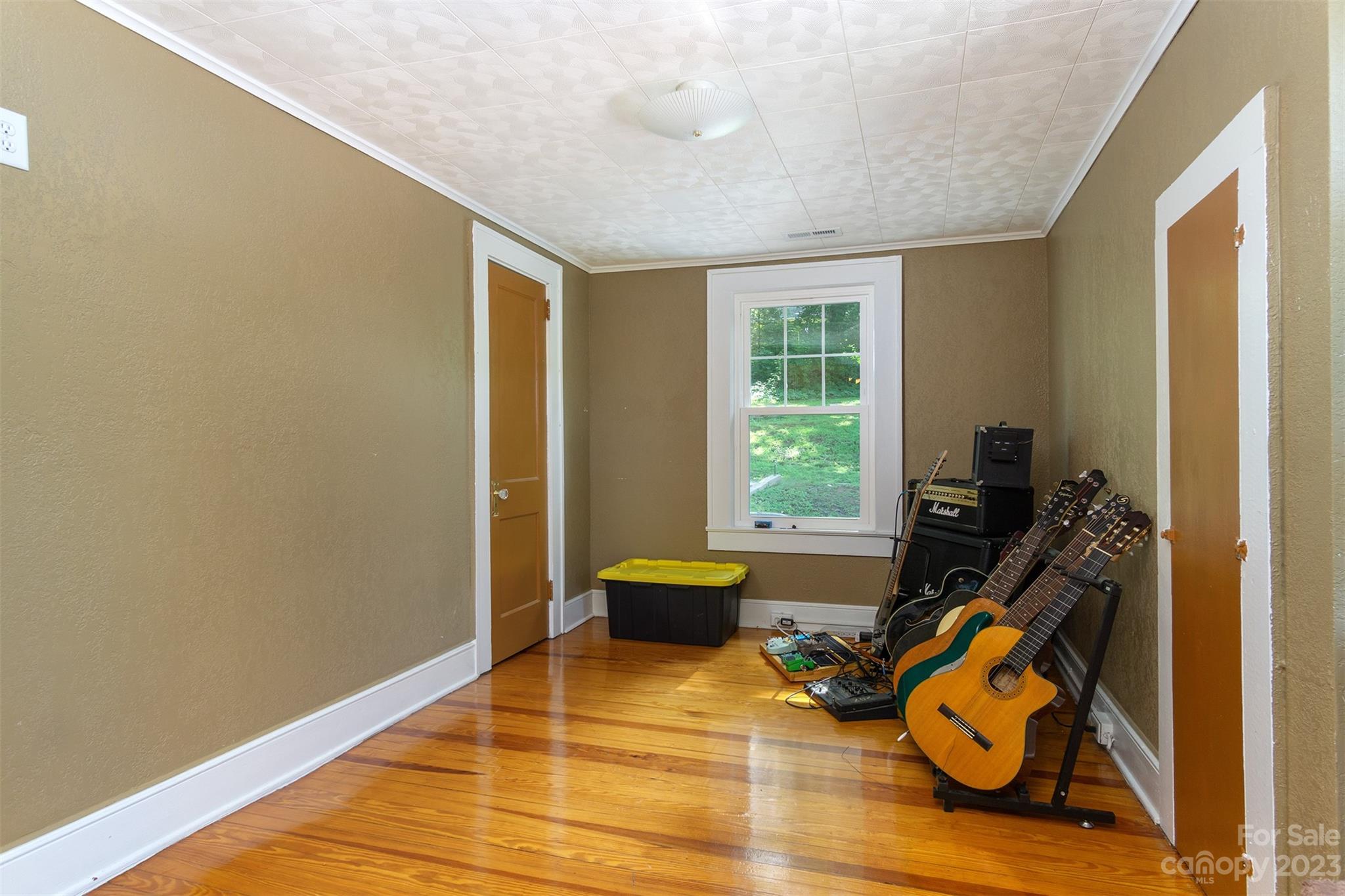 404 Huffman Street Morganton, NC 28655 - Photo 16 of 27 a room with gym equipment and a wooden floor