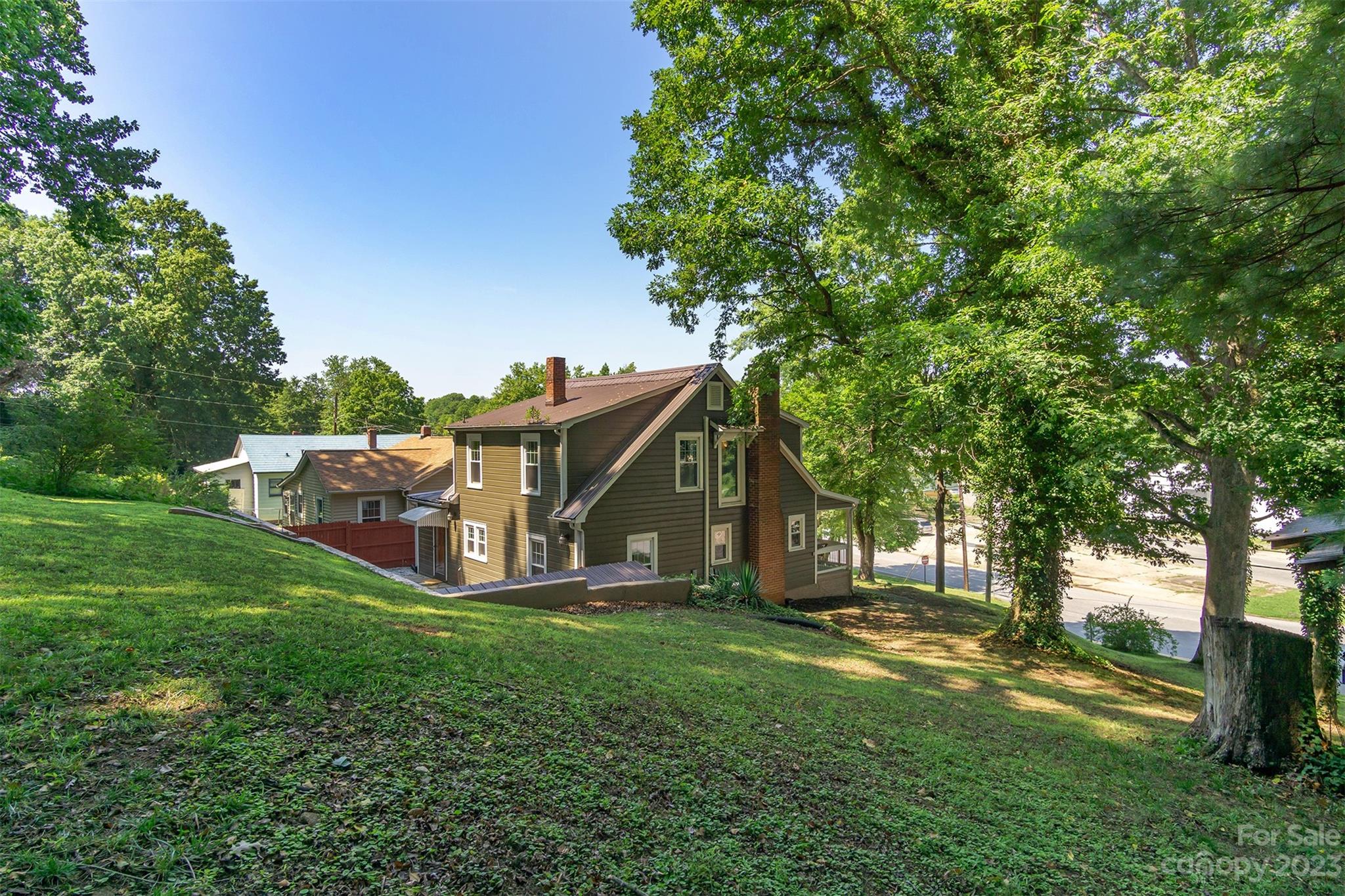 404 Huffman Street Morganton, NC 28655 - Photo 26 of 27 a view of a house with a big yard and large trees