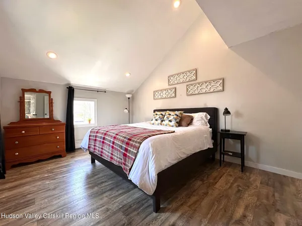 a bedroom with a bed and a dresser