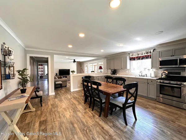 a view of a dining room with furniture and wooden floor
