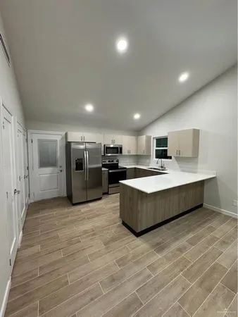 a large room with kitchen view