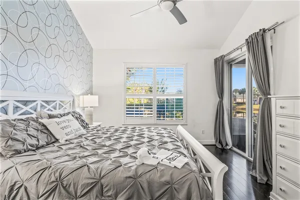 a bedroom with a bed window and a dresser