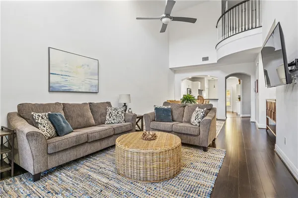 a living room with furniture a rug and a chandelier