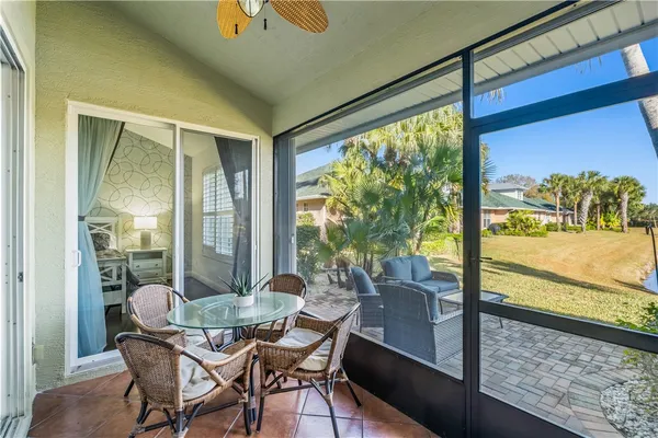 a dining room with furniture and a floor to ceiling window