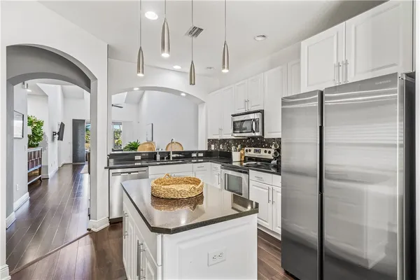 a kitchen with a refrigerator a sink and a stove