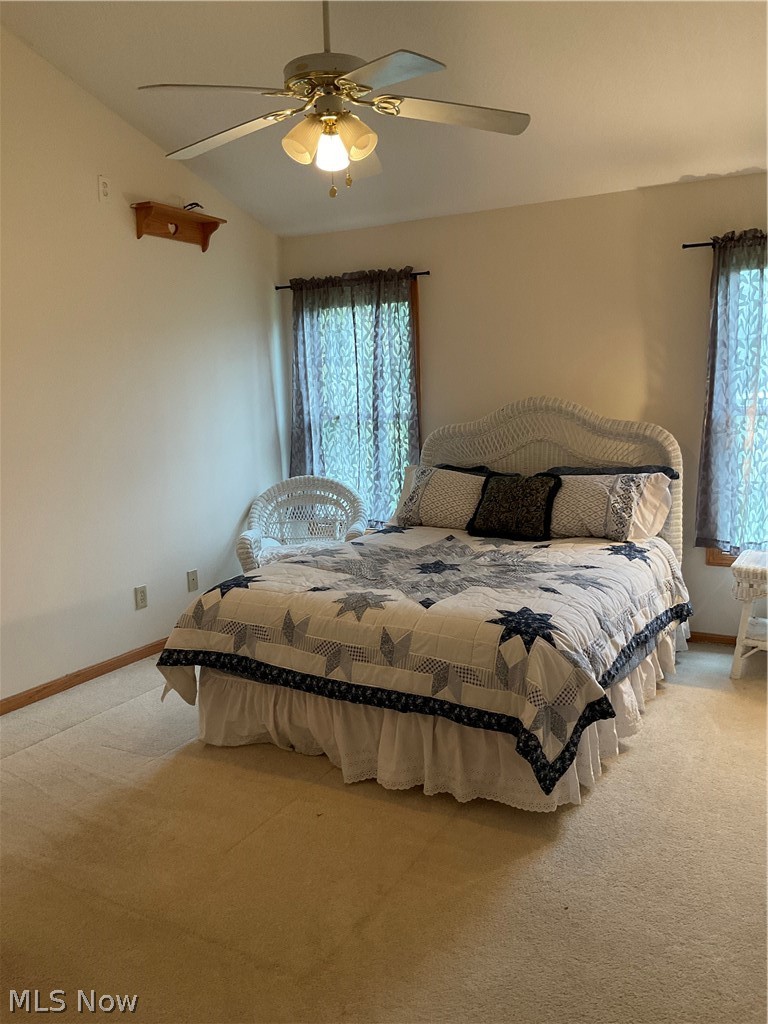 8603 Murray Road Cleveland, OH 44125 - Photo 17 of 26 Bedroom featuring light carpet, lofted ceiling, multiple windows, and ceiling fan