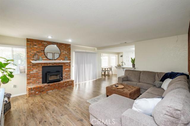 15222 Riverside Drive Apple Valley, CA 92307 - Photo 13 of 43 a living room with furniture a fireplace and a flat screen tv