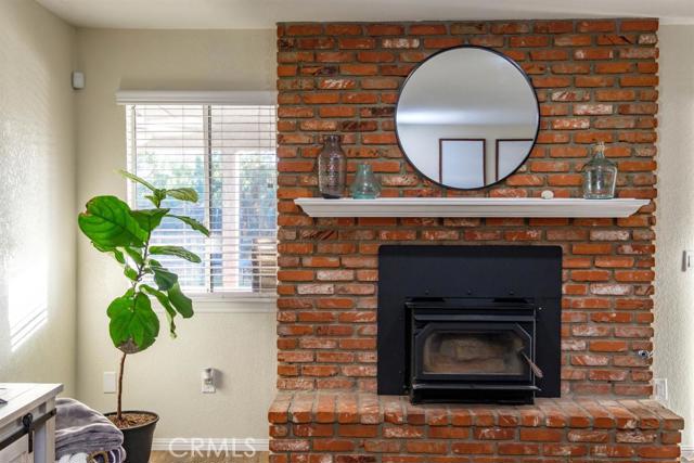 15222 Riverside Drive Apple Valley, CA 92307 - Photo 14 of 43 a living room with a fireplace a potted plant and a fireplace
