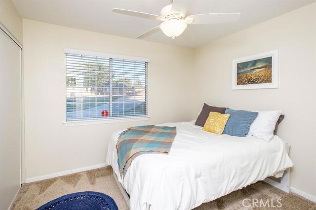 15222 Riverside Drive Apple Valley, CA 92307 - Photo 19 of 43 a bedroom with a bed and a large window