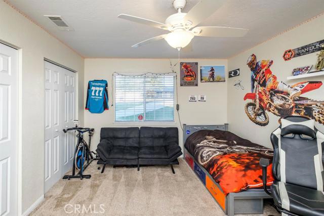 15222 Riverside Drive Apple Valley, CA 92307 - Photo 20 of 43 a bedroom with a bed and a window