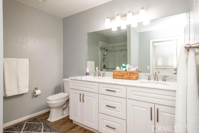 15222 Riverside Drive Apple Valley, CA 92307 - Photo 22 of 43 a bathroom with a sink a toilet and a mirror