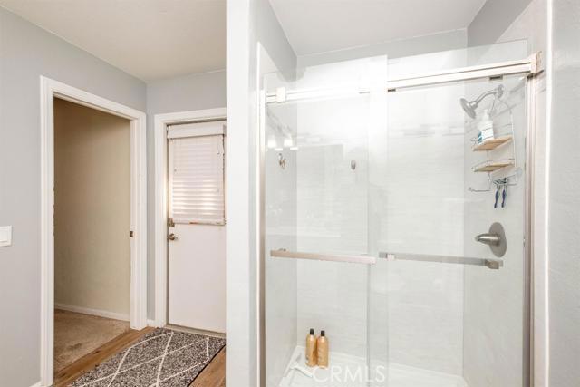 15222 Riverside Drive Apple Valley, CA 92307 - Photo 23 of 43 a bathroom with a glass shower door