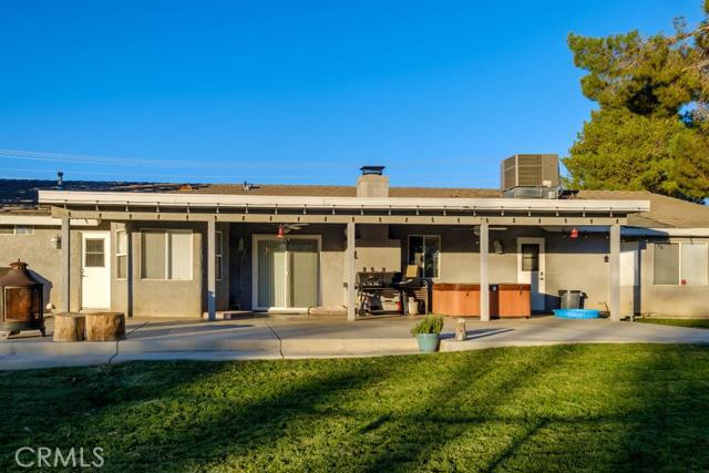 15222 Riverside Drive Apple Valley, CA 92307 - Photo 30 of 43 a view of a house with swimming pool and a yard
