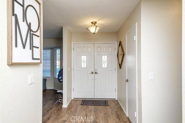 15222 Riverside Drive Apple Valley, CA 92307 - Photo 4 of 43 a view of a hallway with wooden floor and workspace