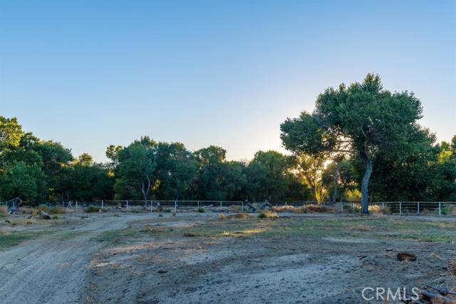 15222 Riverside Drive Apple Valley, CA 92307 - Photo 42 of 43 a view of a field with trees in the background