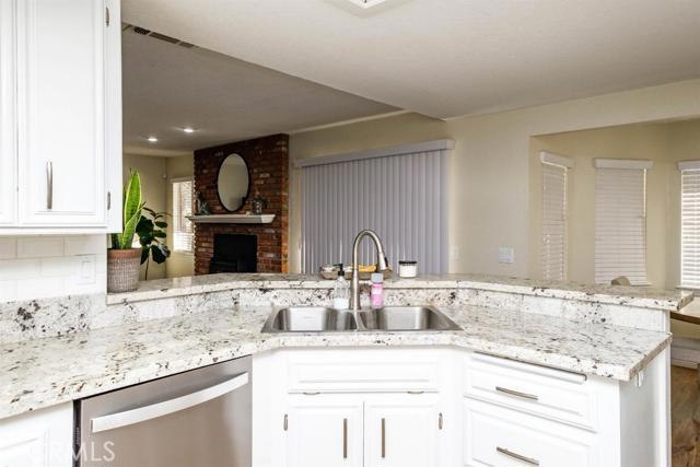 15222 Riverside Drive Apple Valley, CA 92307 - Photo 9 of 43 a kitchen with granite countertop a sink and a stove