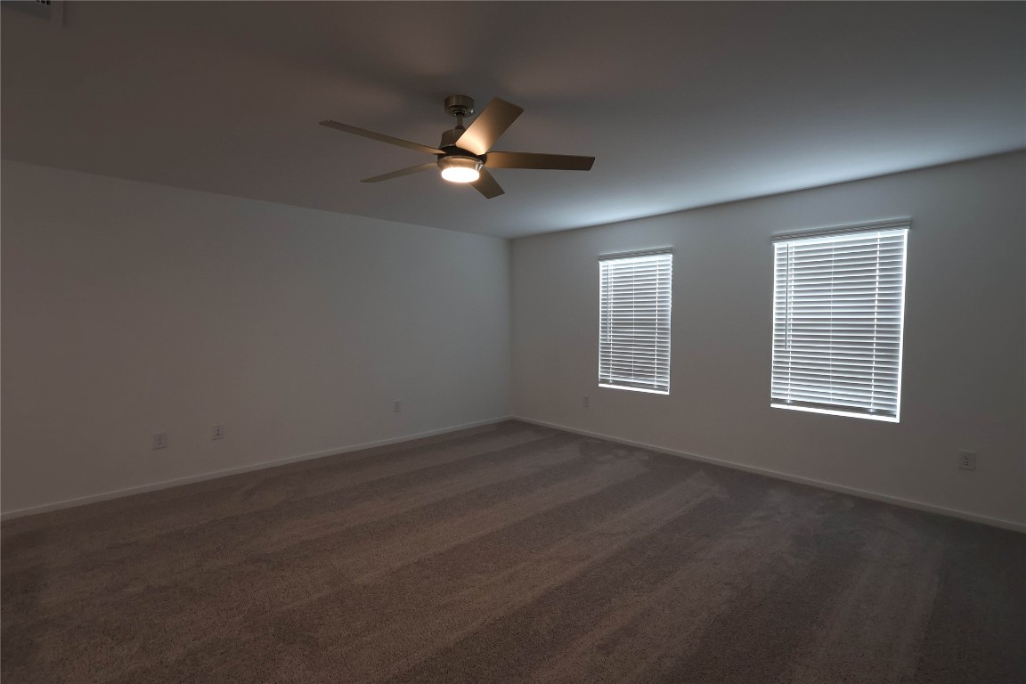 15357 Dapple Blf Lane Conroe, TX 77302 - Photo 11 of 17 an empty room with windows and fan