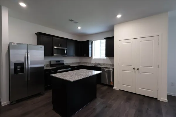 a kitchen with a refrigerator sink and microwave