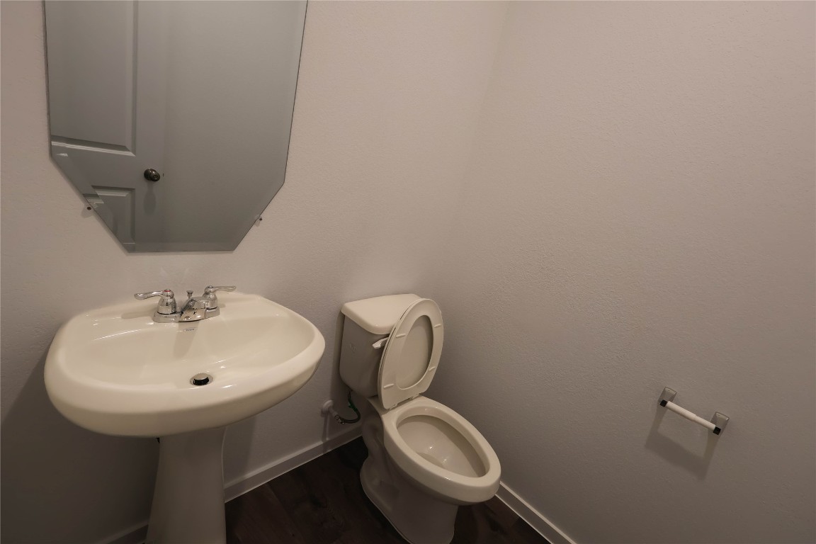 15357 Dapple Blf Lane Conroe, TX 77302 - Photo 10 of 17 a bathroom with a toilet sink and mirror