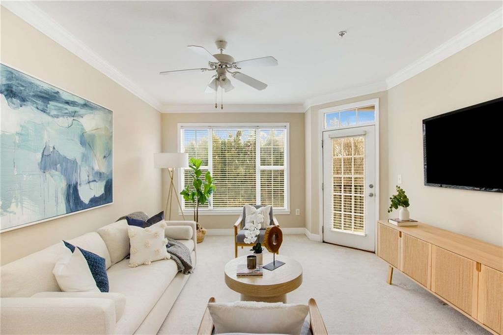 1308 Stratford Commons Decatur, GA 30033 - Photo 1 of 1 a living room with furniture a flat screen tv and a large window