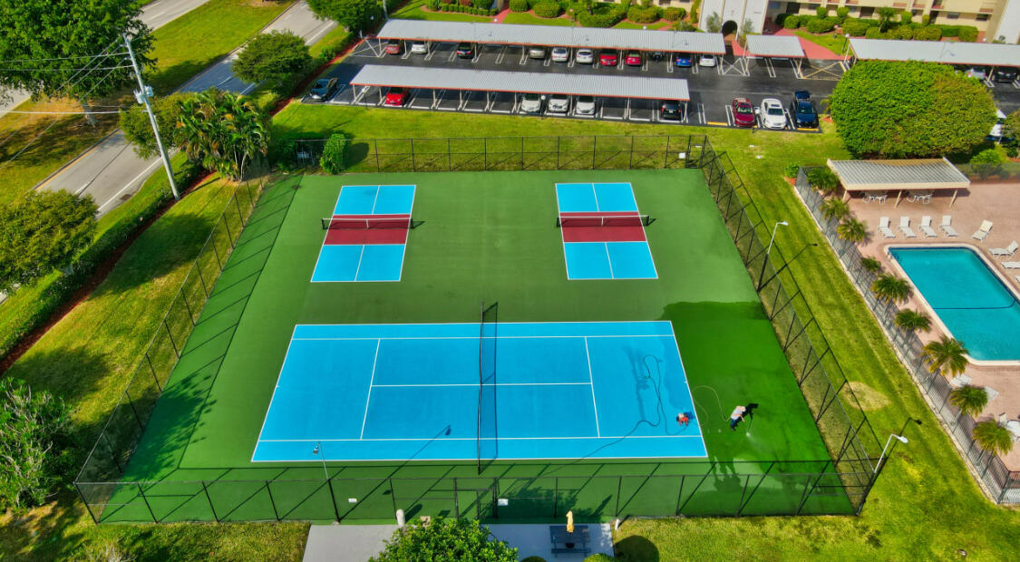 23249 Barwood Lane North, Unit 402 Boca Raton, FL 33428 - Photo 22 of 27 an aerial view of a multi story residential apartment building with yard and green space
