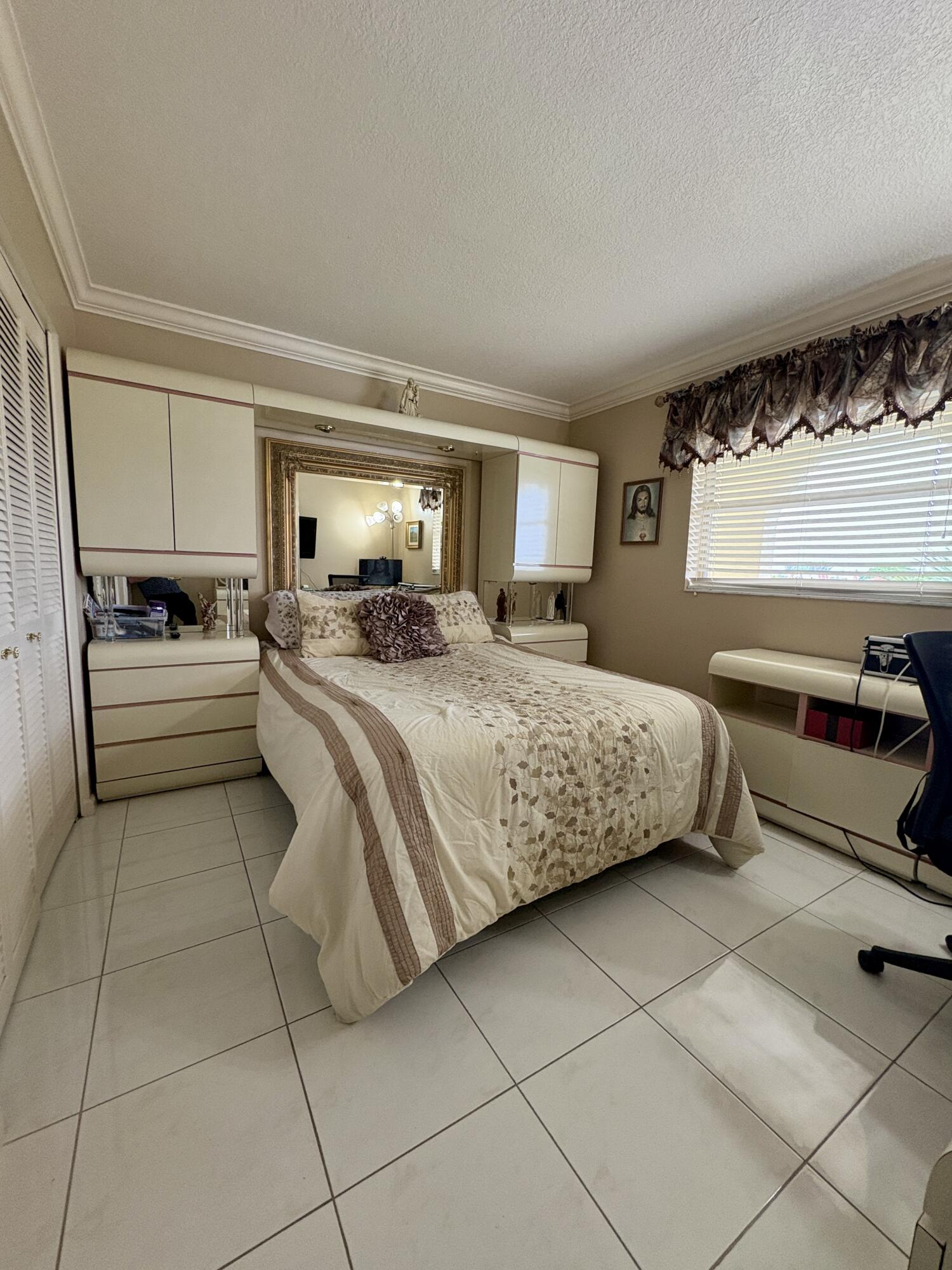 23249 Barwood Lane North, Unit 402 Boca Raton, FL 33428 - Photo 10 of 27 a bedroom with a bed and a couch