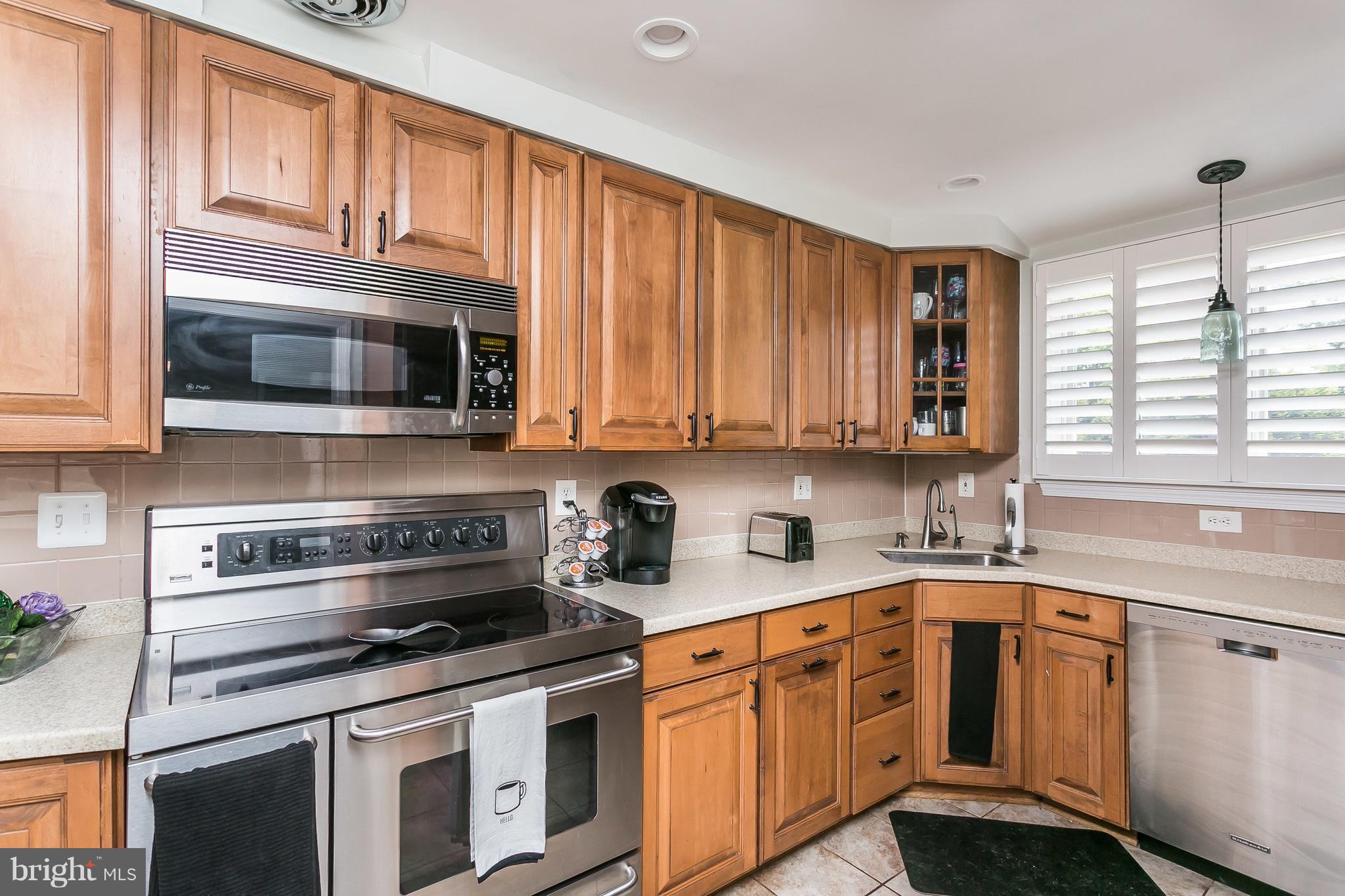 13902 Baldwin Mill Road Baldwin, MD 21013 - Photo 12 of 30 a kitchen with stainless steel appliances granite countertop a sink a stove a microwave and cabinets