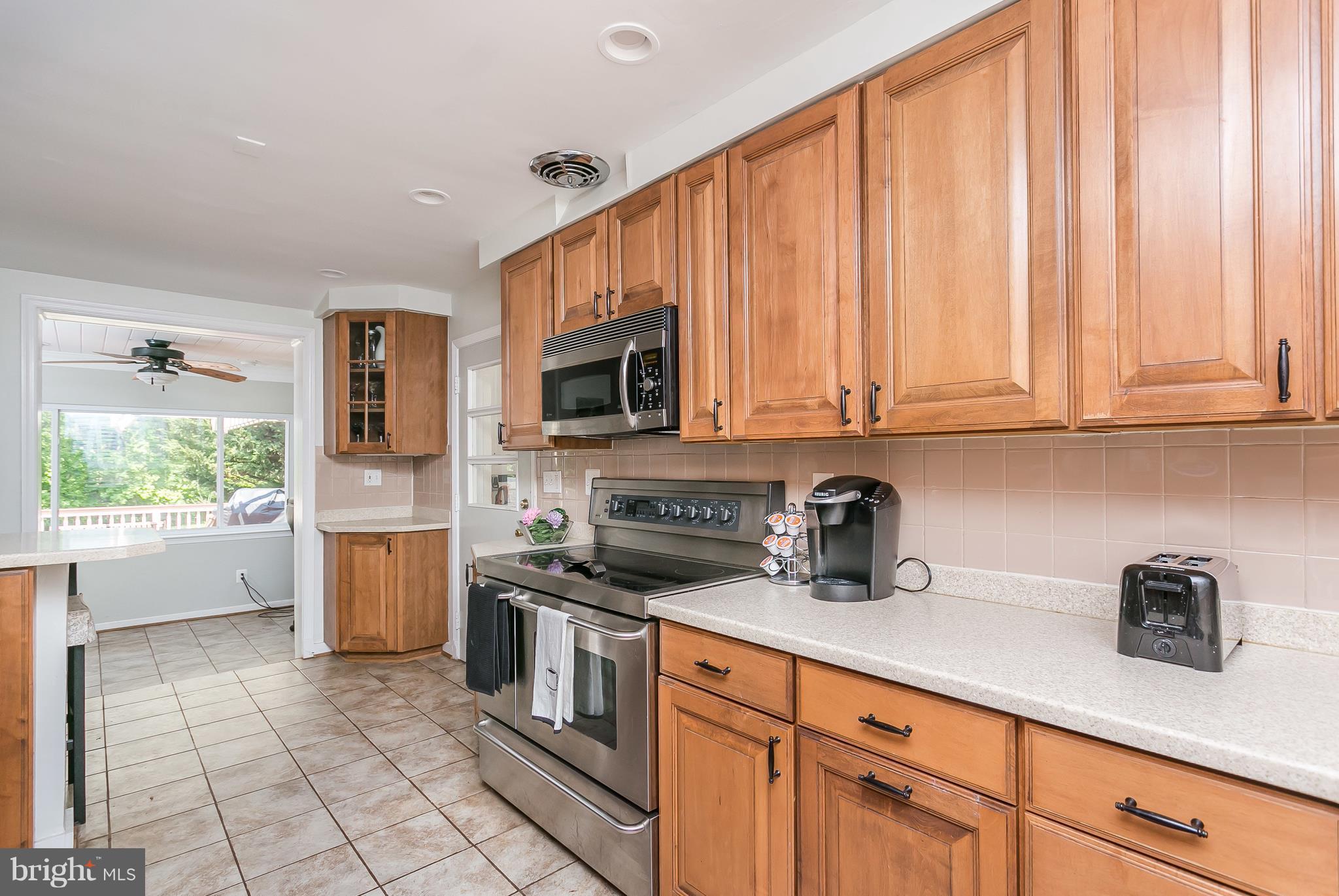 13902 Baldwin Mill Road Baldwin, MD 21013 - Photo 14 of 30 a kitchen with stainless steel appliances granite countertop a stove a sink and a white cabinets